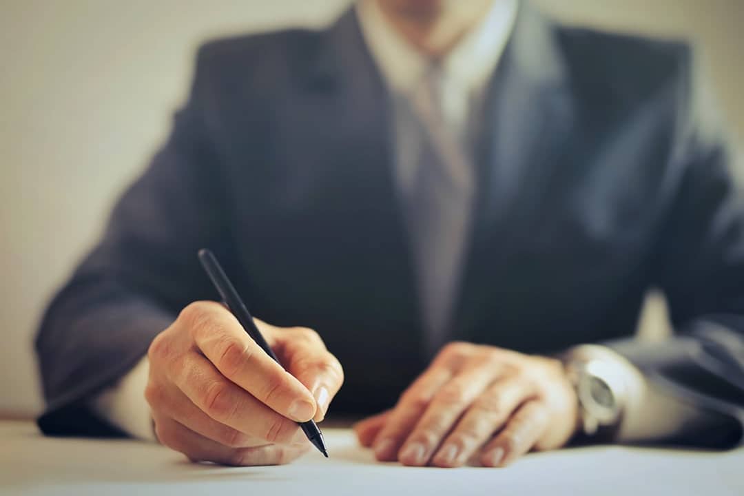A car agent signing a contract.